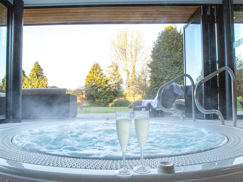 two glasses of Champagne on the edge of the Stratton House Hotel and Spa Cotswolds