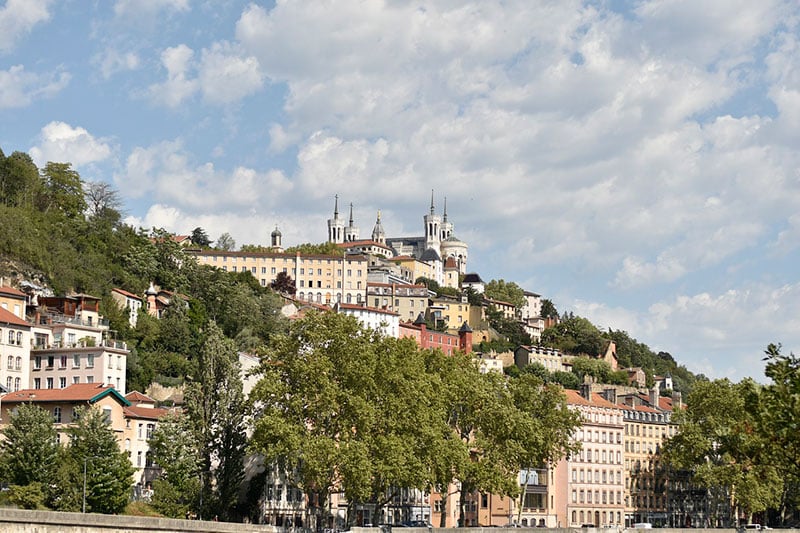 A photo of beautiful buildings, including a castle, in Lyon, France.