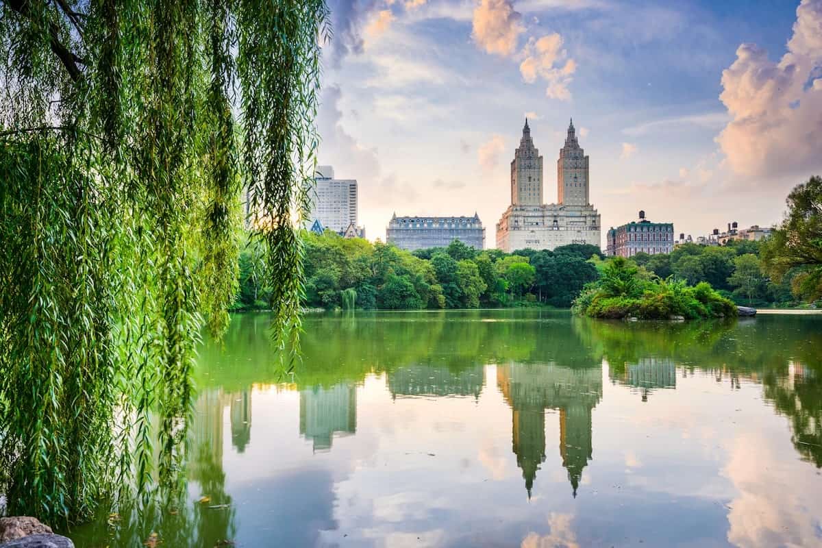 View of the Central Park Lake looking toward the Upper West Side with buildings reflected on the water
