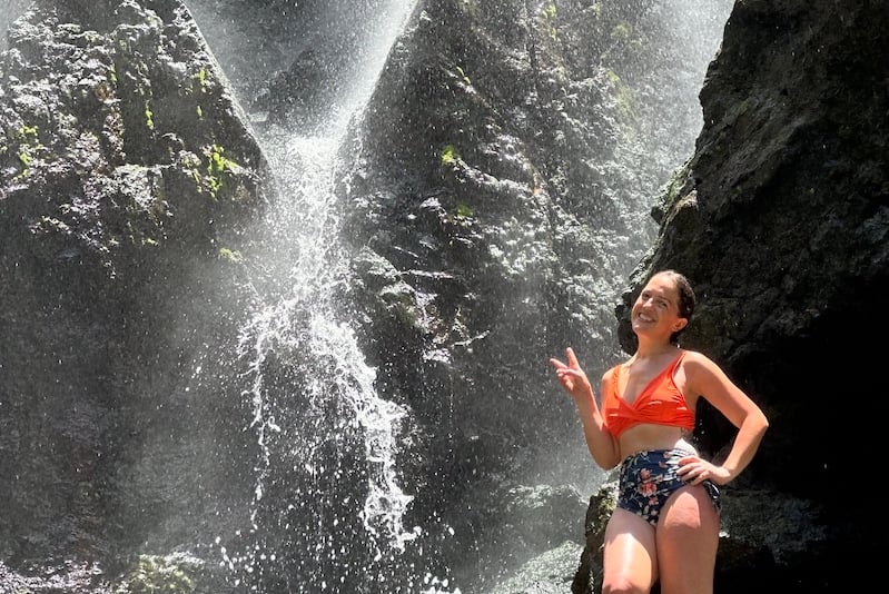 woman hiking Charco Prieto Waterfall in Puerto Rico