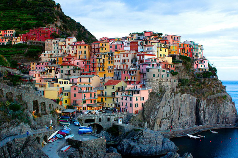 A photo of colorful houses on a cliff in Manarola, Italy.