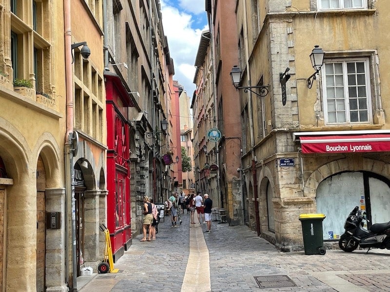 traveler wandering a narrow street in Old Lyon during a weekend in the city