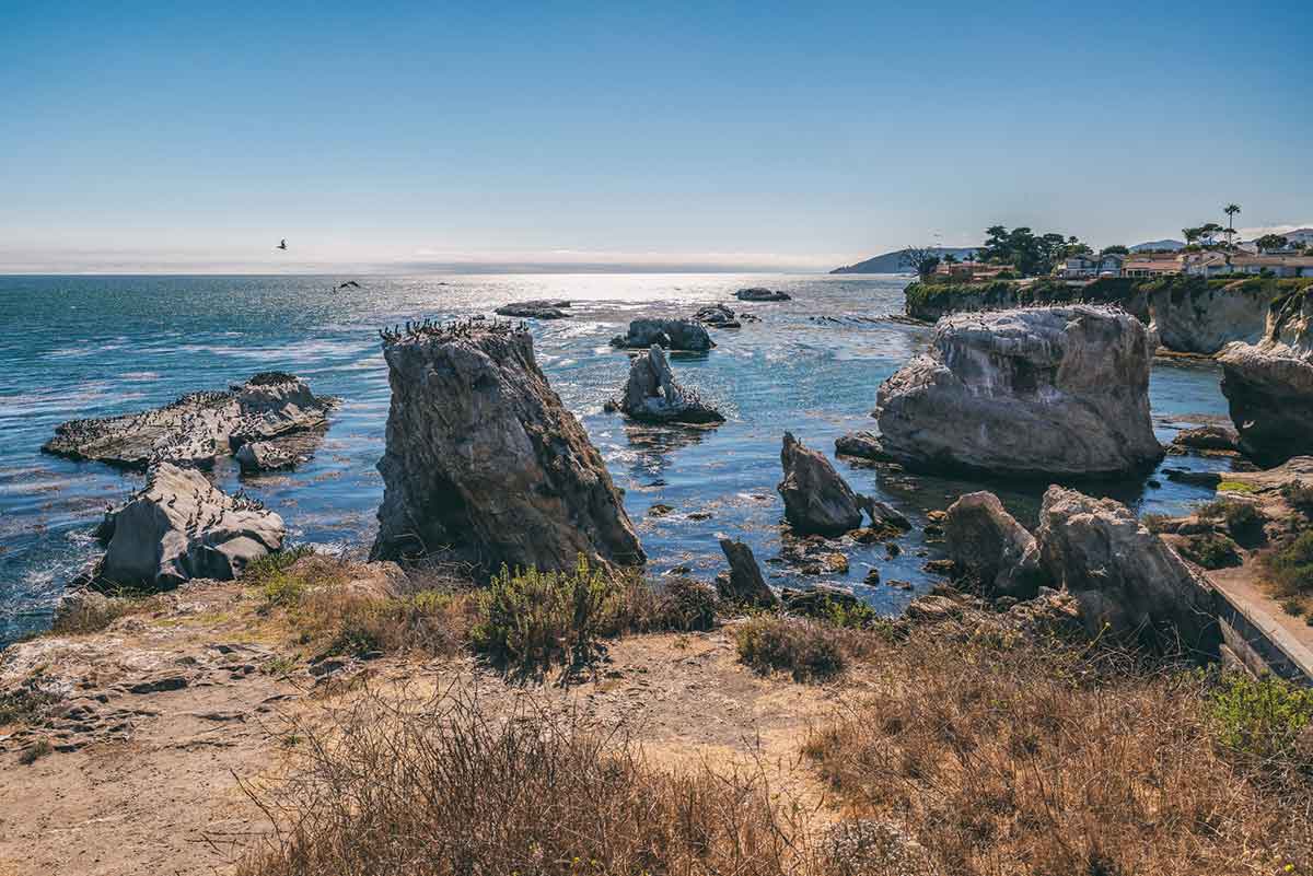 Cliffs, Rocks, Arches, and Flock of Birds. Shell Beach Area of Pismo Beach, California.