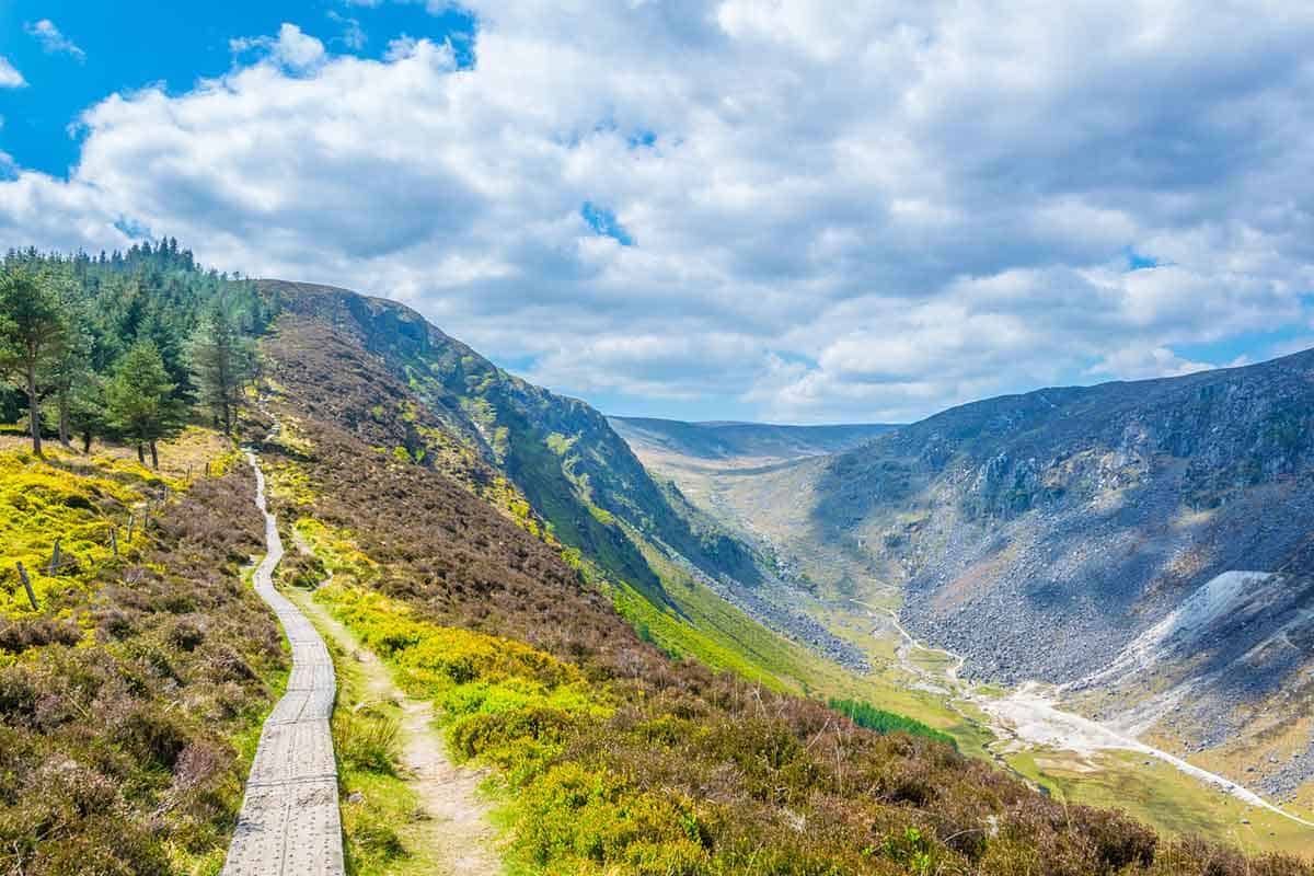 A panoramic path winding over Glendalough, Ireland.