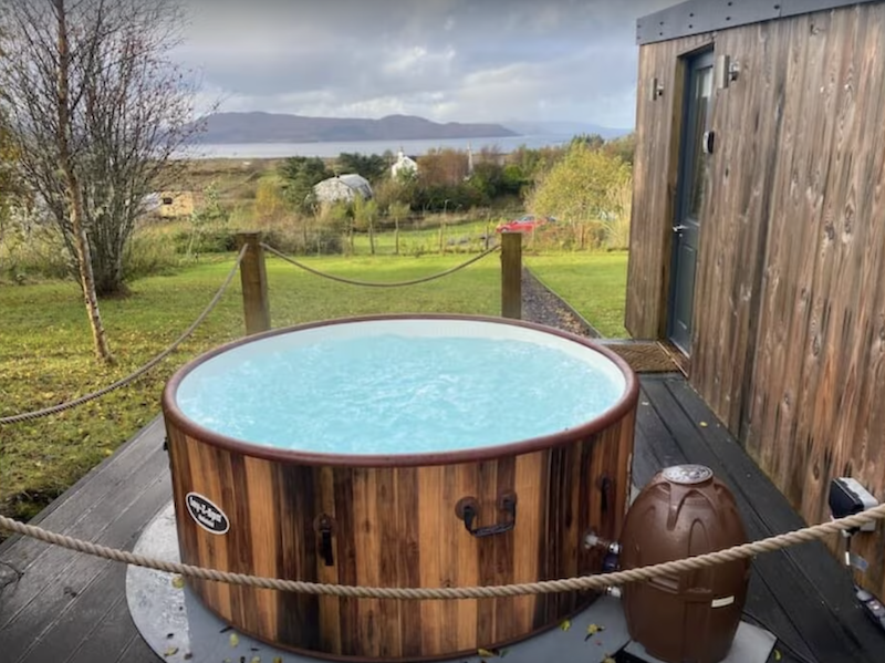 cabin with a private hot tub in Scotland overlooking the water