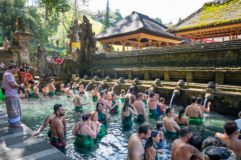 people doing a water ritual at Tirta Empul Water Temple
