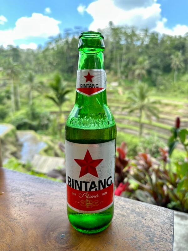 traveler drinking a local Bintang beer while traveling Bali for 2 weeks