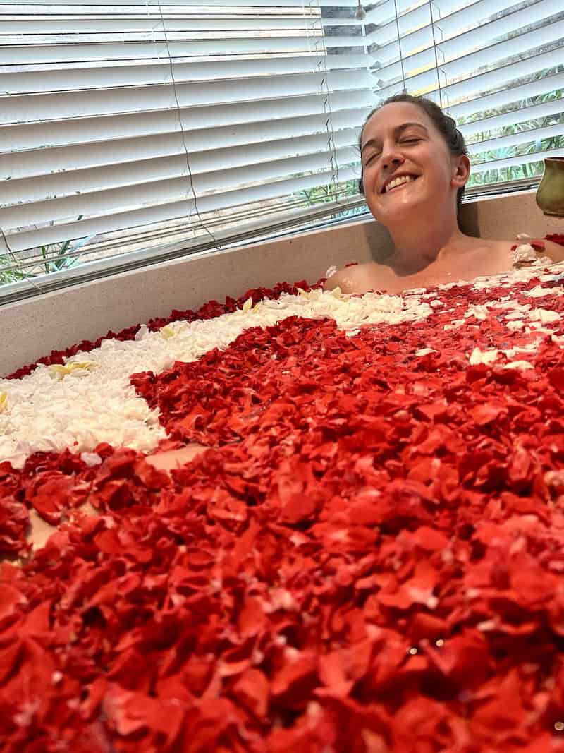 woman getting a flower bath in Bali