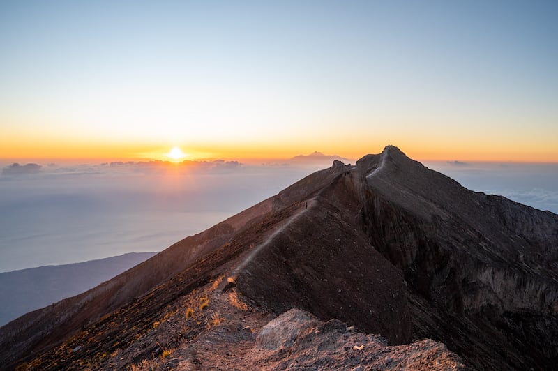 traveler seeing a Mount Agung sunrise after hiking the Besakih Temple Route