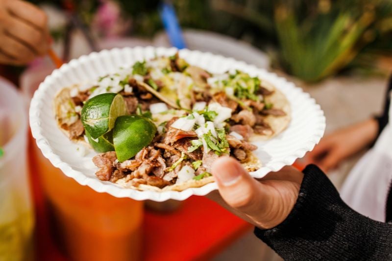 solo traveler eating tacos al pastor in Mexico City