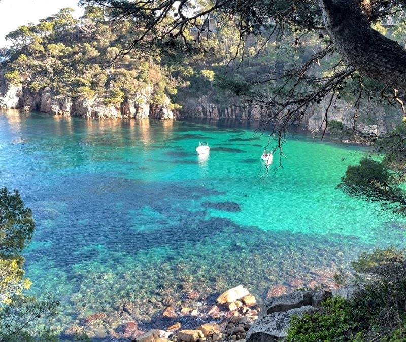 woman visiting a clear water cove in Costa Brava while traveling solo in Spain