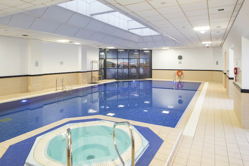 indoor swimming pool with a hot tub on the side at the Crowne Plaza Hotel Glasgow