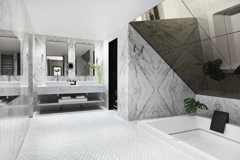 black and white marble bathroom with a white indoor Jacuzzi at the  Kimpton Blythswood Square hot tub hotel in Glasgow