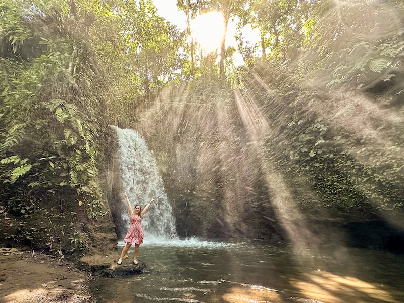 female traveler posing in front of Manuaba Waterfall around Ubud