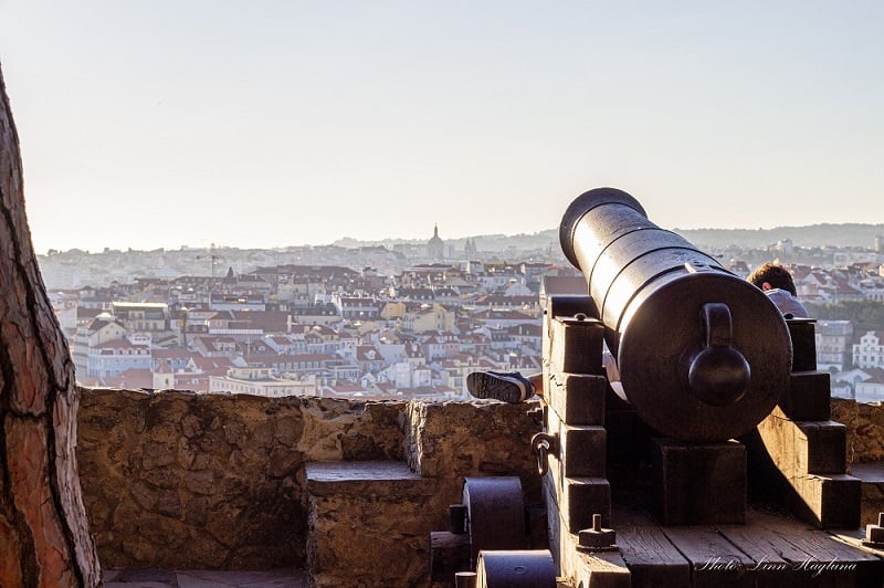solo traveler in Lisbon taking in the views over the city from São Jorge Castle