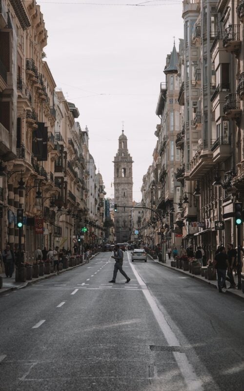 Spain solo traveler walking up a street that leads to the Cathedral of Valencia