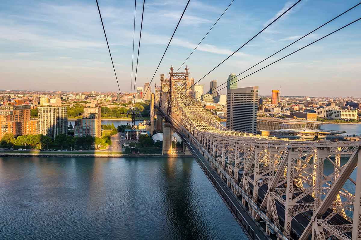 Aerial view of Ed Koch Queensboro Bridge looking to Roosevelt Island at sunset, New York City.