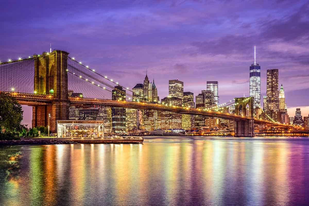 New York skyline from Brooklyn Bridge at night.