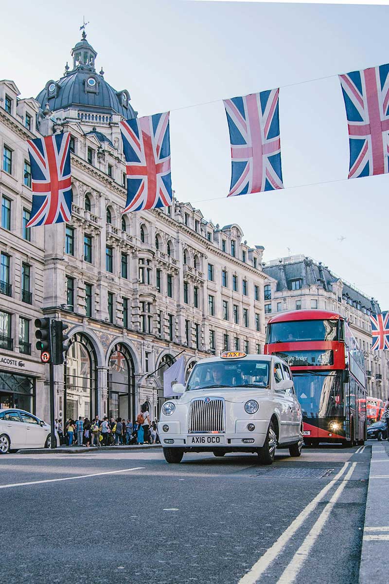 A photo of a car and red double decker bus in Oxford Street in London.