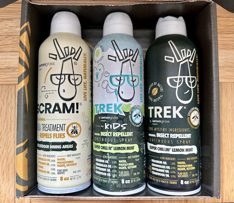 open box showcasing three cans of  TREK All Natural Insect Repellant from Lemongrass Farms