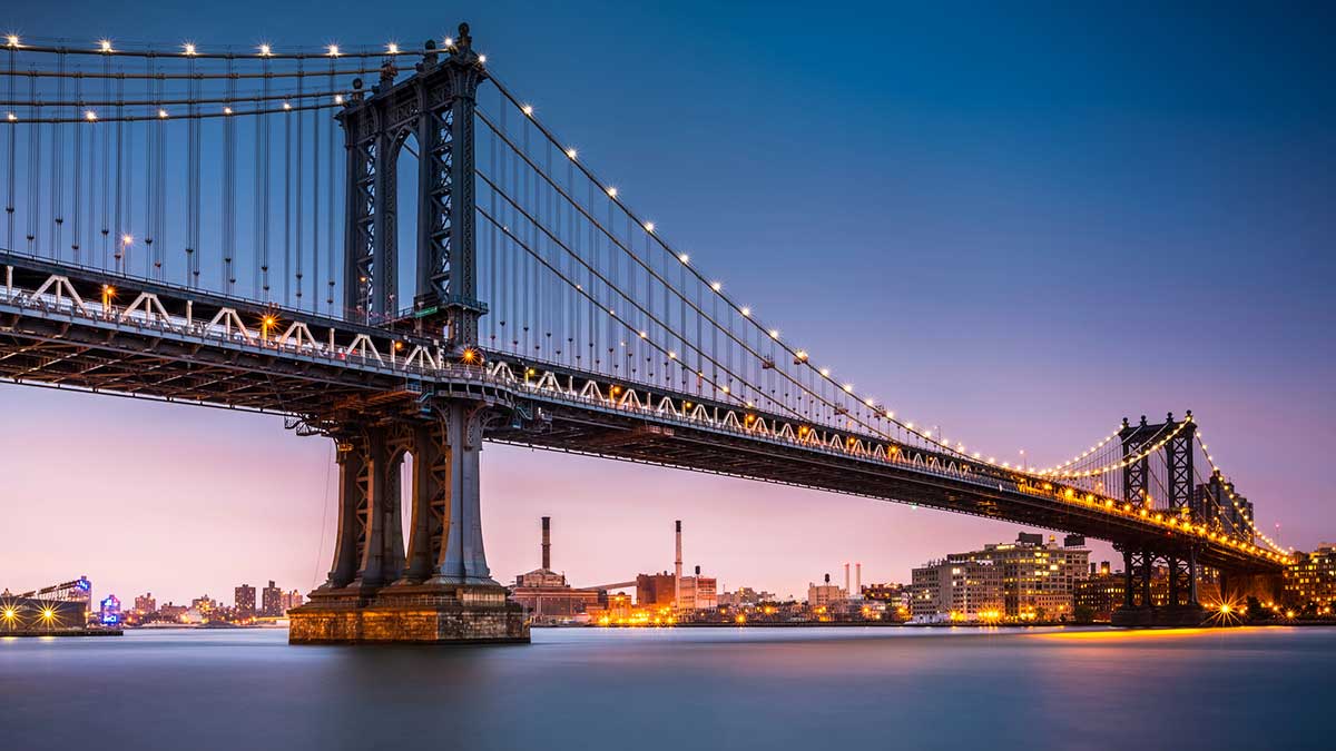 Manhattan Bridge illuminated at dusk.
