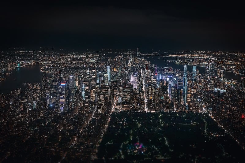 Aerial view of New York City at night from a helicopter tour