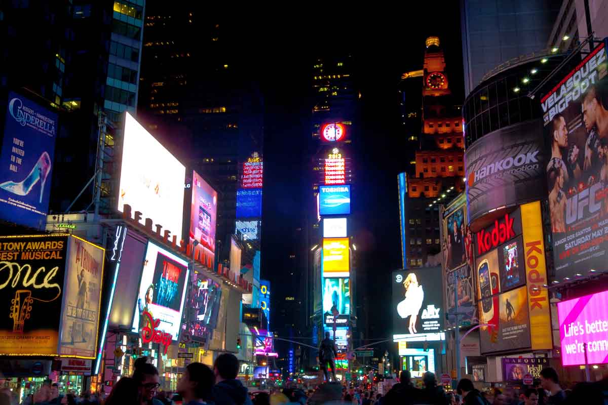Times Square NYC billboards lit up at night.