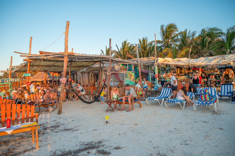 hammocks and picnic tables on the beach at Capitán Capitán Beach Club in Isla Holbox, Mexico