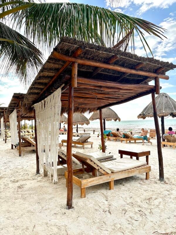 lounge chairs in the sand at La Playa de Ñaña Holbox