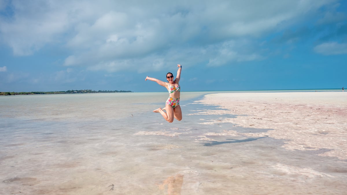 woman walking on the sandbar at Mosquito Point in Holbox Island, Mexico