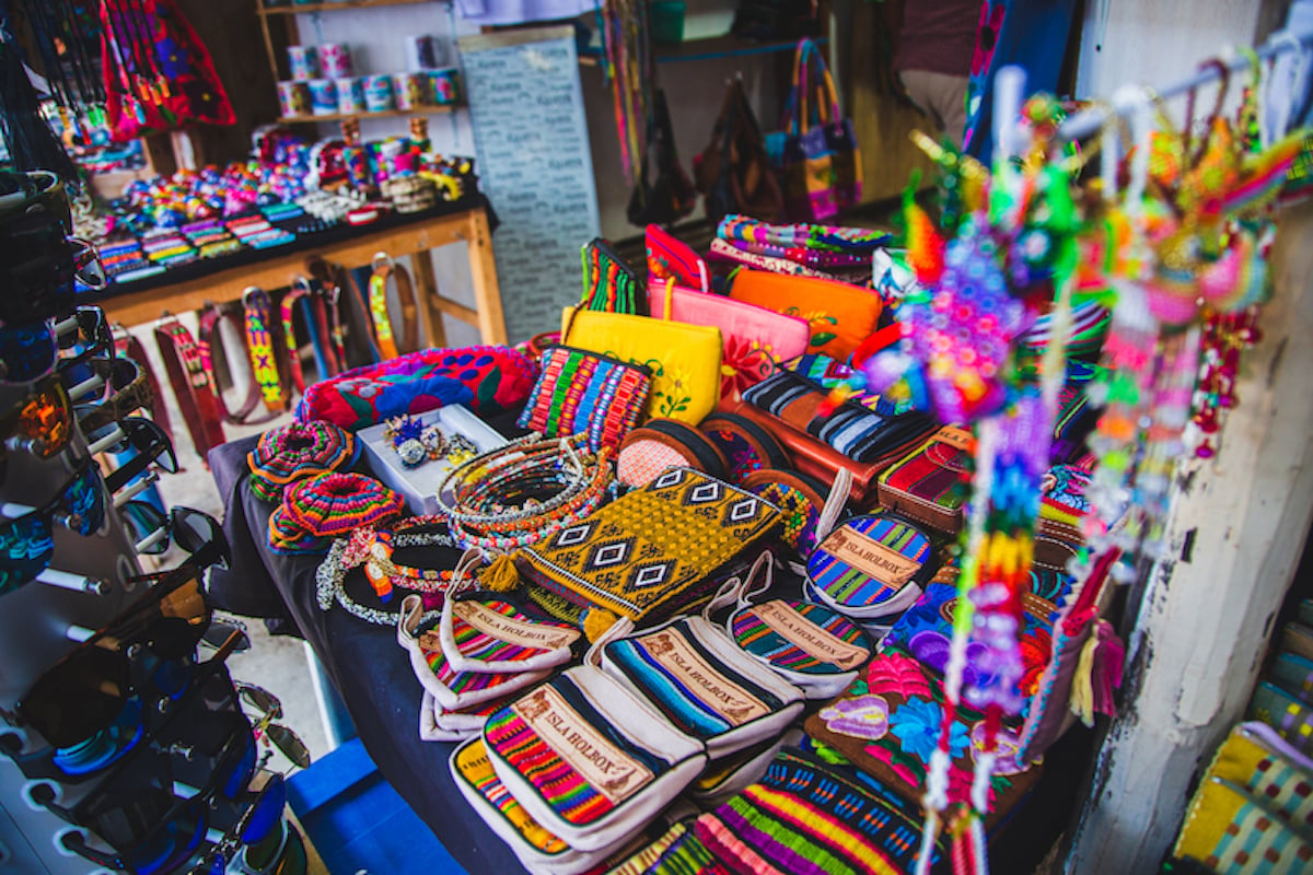 tables of colorful bracelets, purses, and keychains being sold as souvenirs on Holbox Island, Mexico