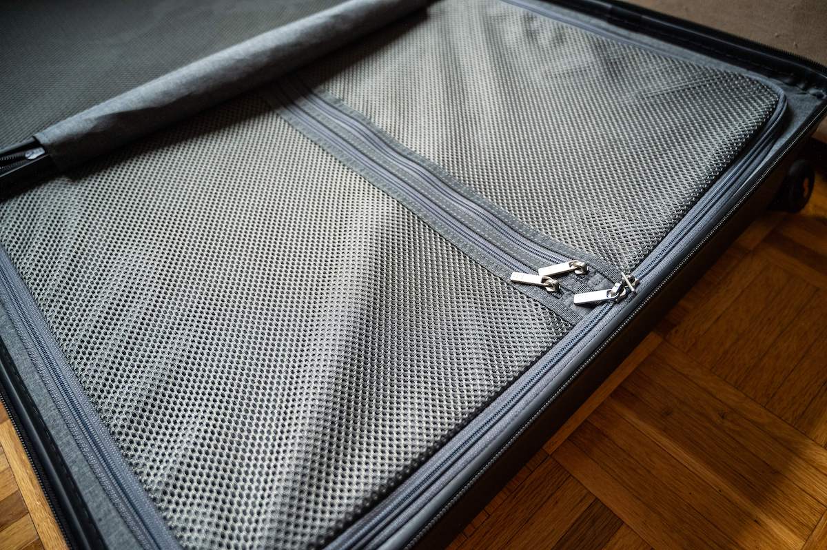 interior compartment of the LEVEL8 Luminous Textured 2 Piece Set  aluminum suitcase with a double mesh zipper compartment on one side