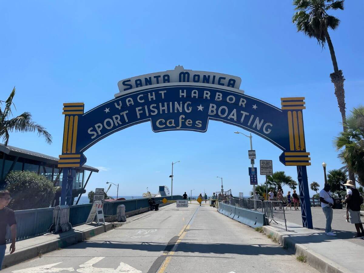 sign welcoming visitors to the Santa Monica Pier in Los Angeles, California