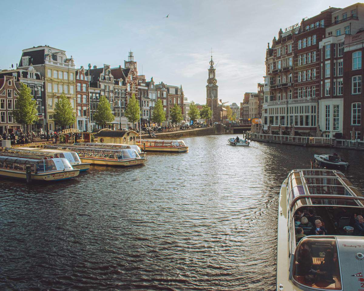 The Amstel Canal and the View of Westerkerk Church in Amsterdam, the Netherlands