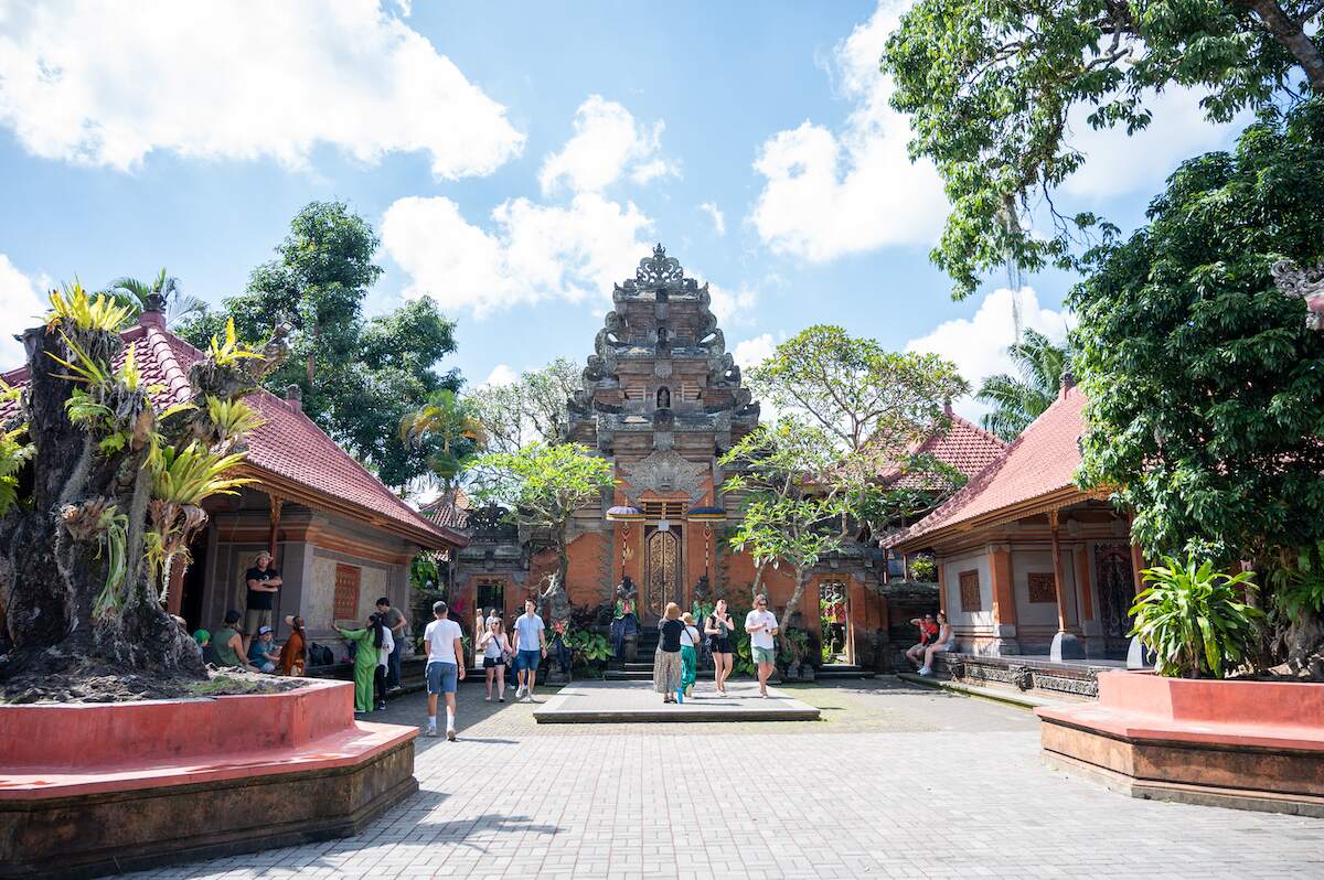 Tourists visiting the historic Ubud Palace, a popular attraction in Ubud, Bali, known for its beautiful architecture and cultural significance