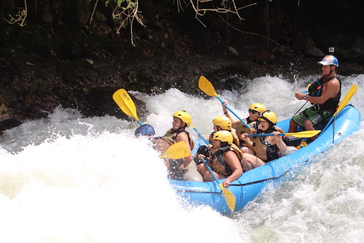 Thrilling white water rafting adventure in La Fortuna, Costa Rica, with a group of rafters navigating the rapids, showcasing an exciting activity in a 5 day Costa Rica itinerary.