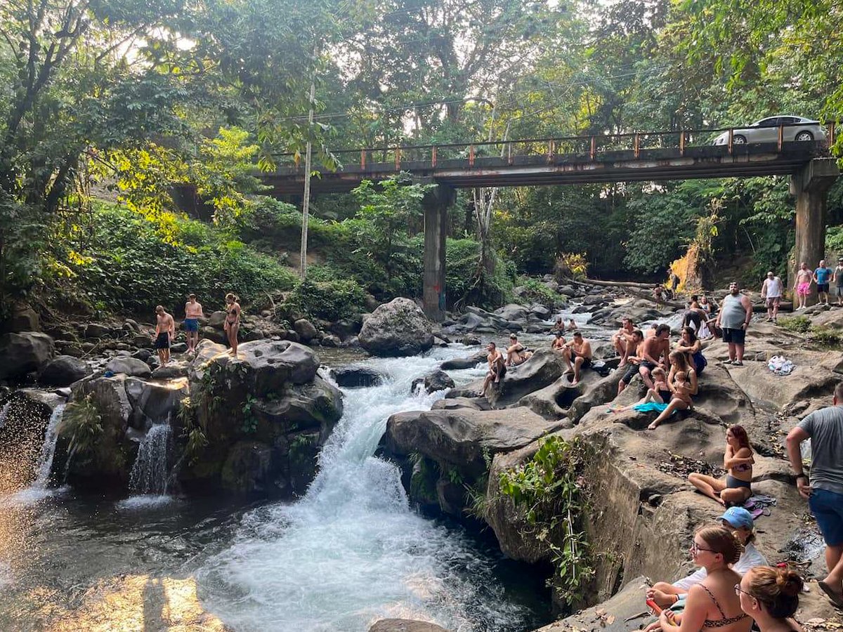 Visitors enjoying the natural beauty and refreshing waters at El Salto swimming hole in La Fortuna, Costa Rica, a popular spot included in a 5 day Costa Rica itinerary.