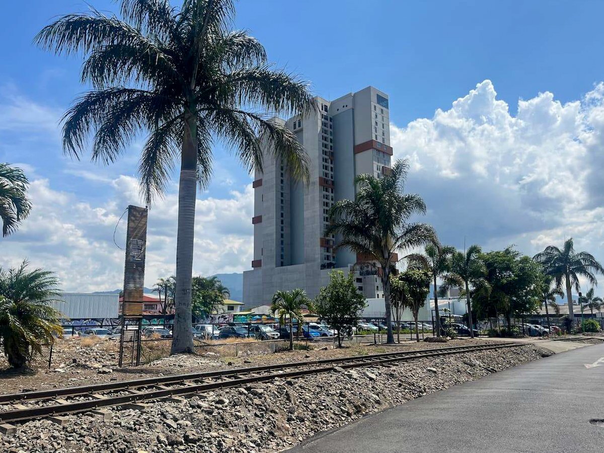 Modern high-rise building surrounded by palm trees in San Jose, Costa Rica, capturing the urban landscape as part of a 5 days in Costa Rica travel itinerary.