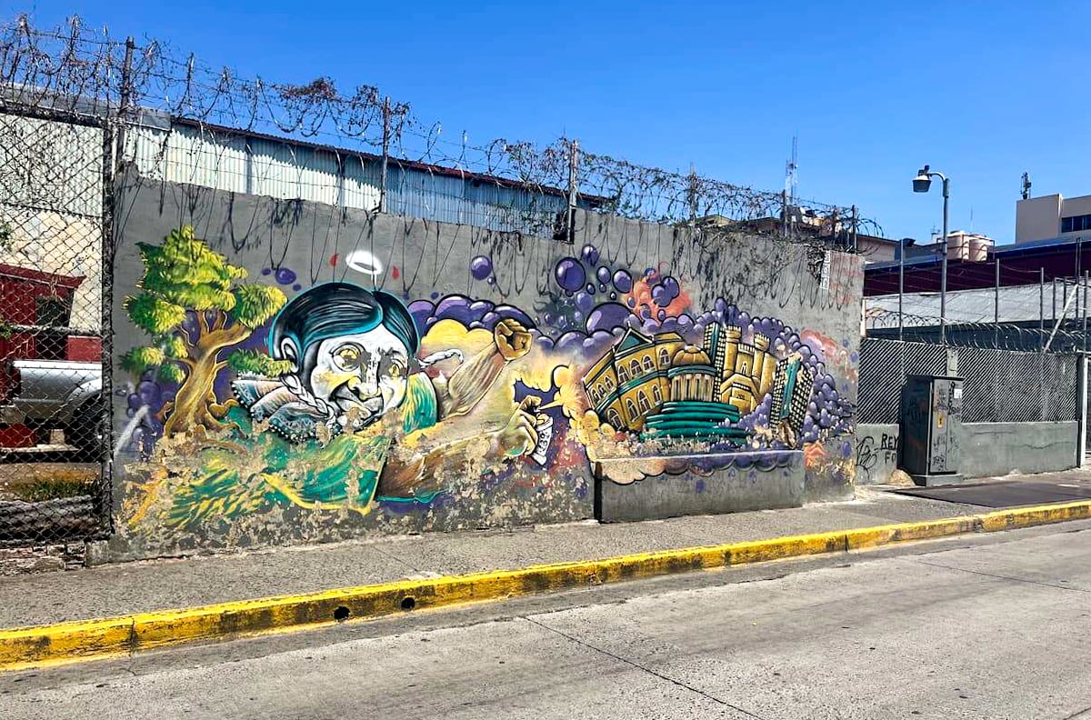 Vibrant street art on a wall in San Jose, Costa Rica, featuring colorful graffiti depicting urban and cultural themes, part of a vacation itinerary.