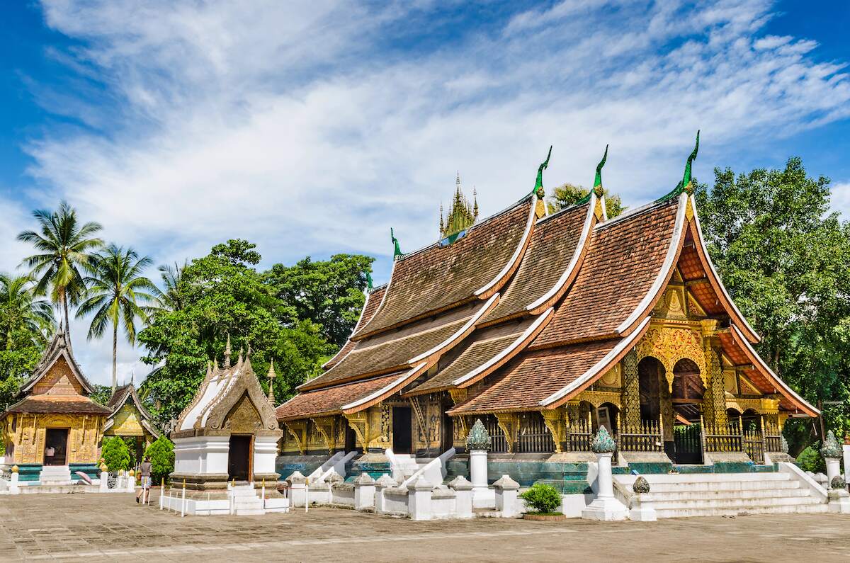 Wat Xieng Thong temple in Luang Prabang featuring intricate traditional architecture with ornate details and a serene courtyard, an essential visit for solo travelers exploring Laos.