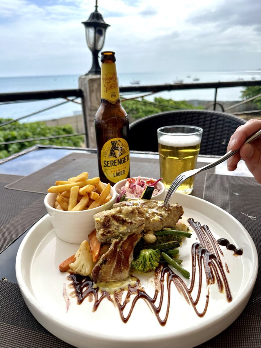 travelers having a seafood lunch of the rooftop of Africa House Hotel in Stone Town, Zanzibar