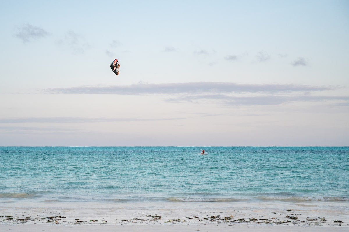 person kitesurfing at sunset on Paje Beach in Zanzibar