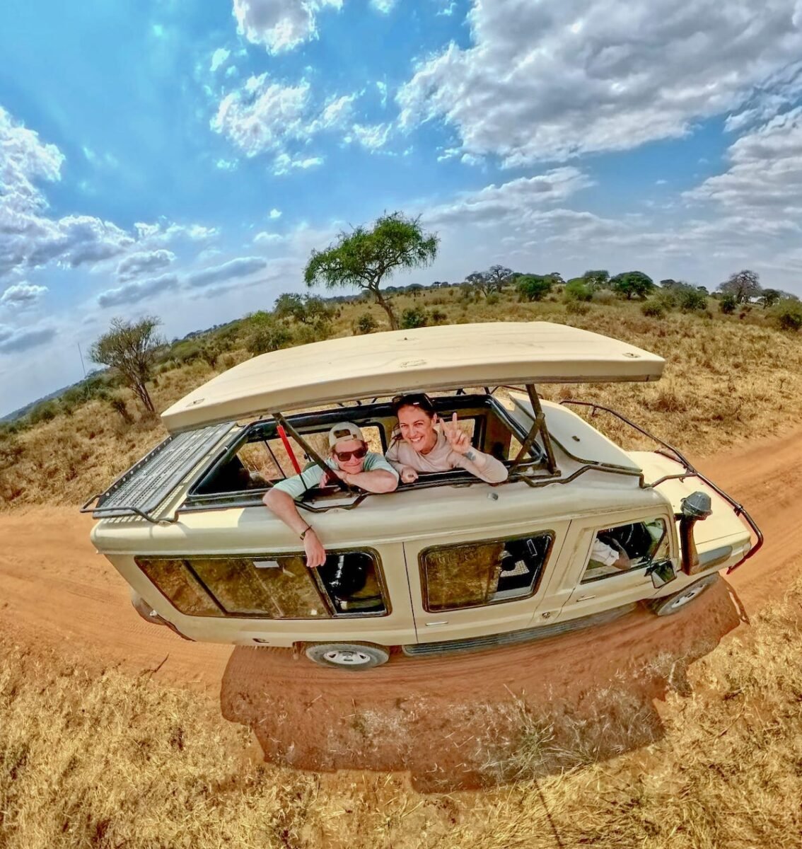 two travelers in a private safari vehicle with the top popped up in Tarangire National Park in Tanzania