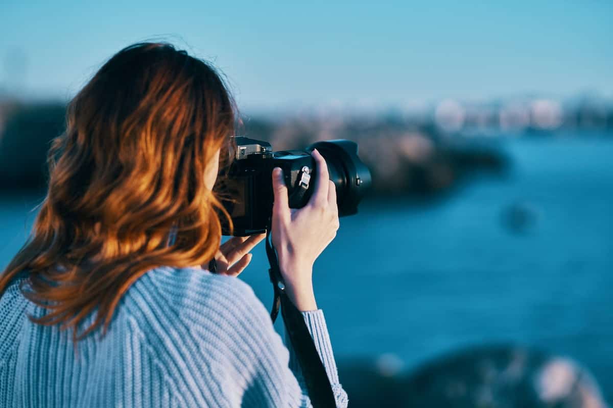 travel content creator taking landscape photos from her trip to license and sell back to the tourism board
