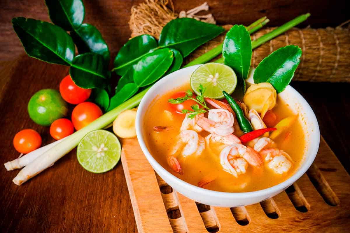 A photo of a bowl with Tom yum soup, a Thai dish.