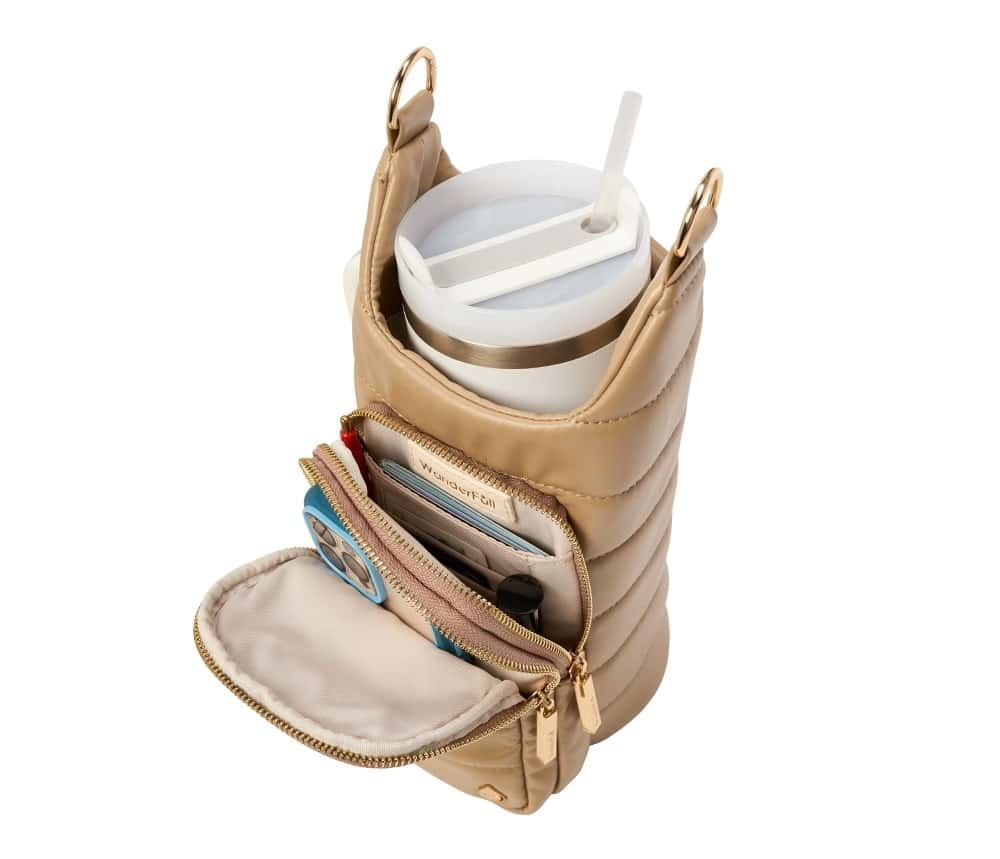 gold-colored WanderFull HydroBag containing a phone, cash, lip gloss, and water bottle