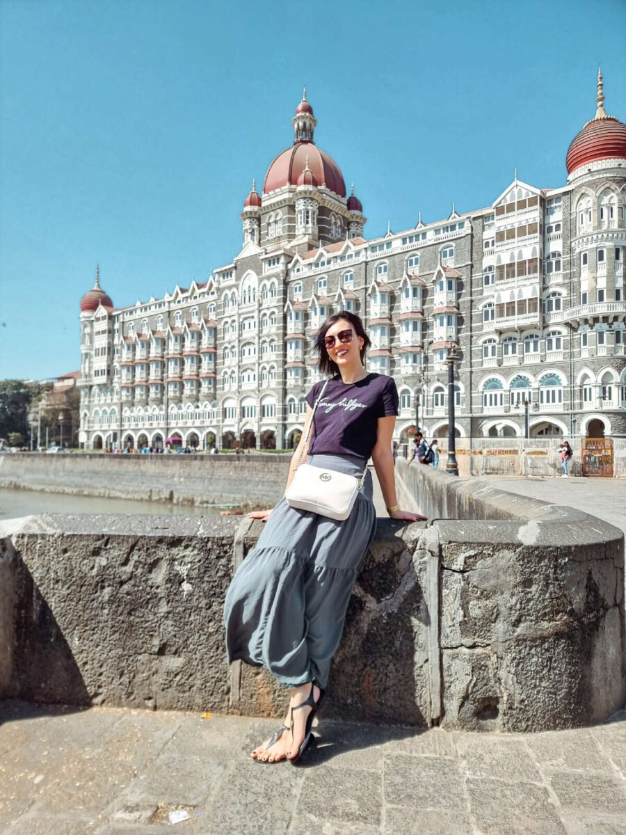 solo female traveler in Mumbai standing in front of the Taj Mahal Palace luxury hotel