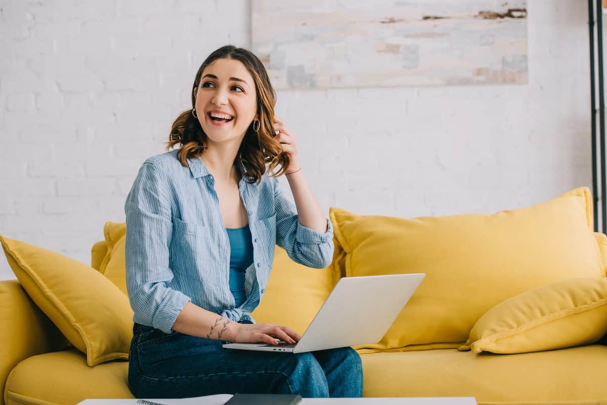 female blogger sitting on the couch doing a free digital product launch challenge