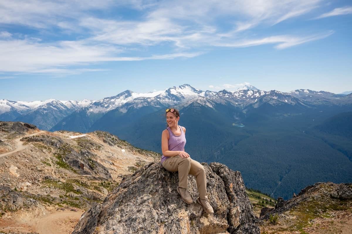 woman standing on the Top of the World peak at Whistler