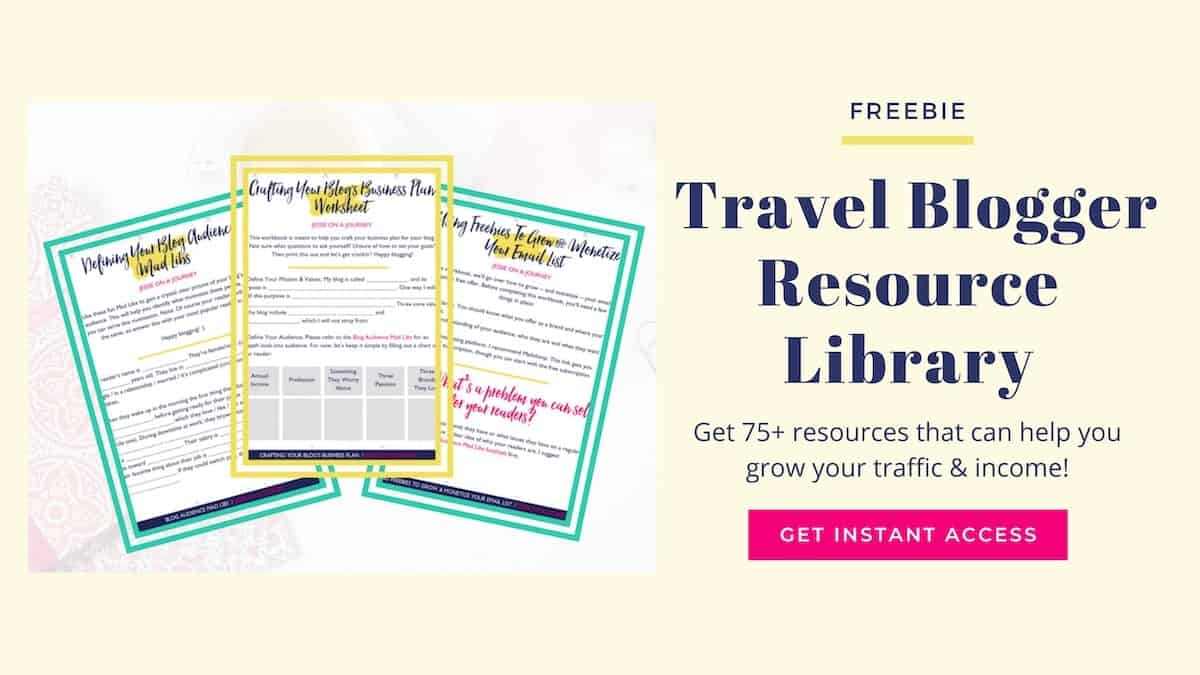 resources from a free Travel Blogger Resource Library fanned out on a yellow background
